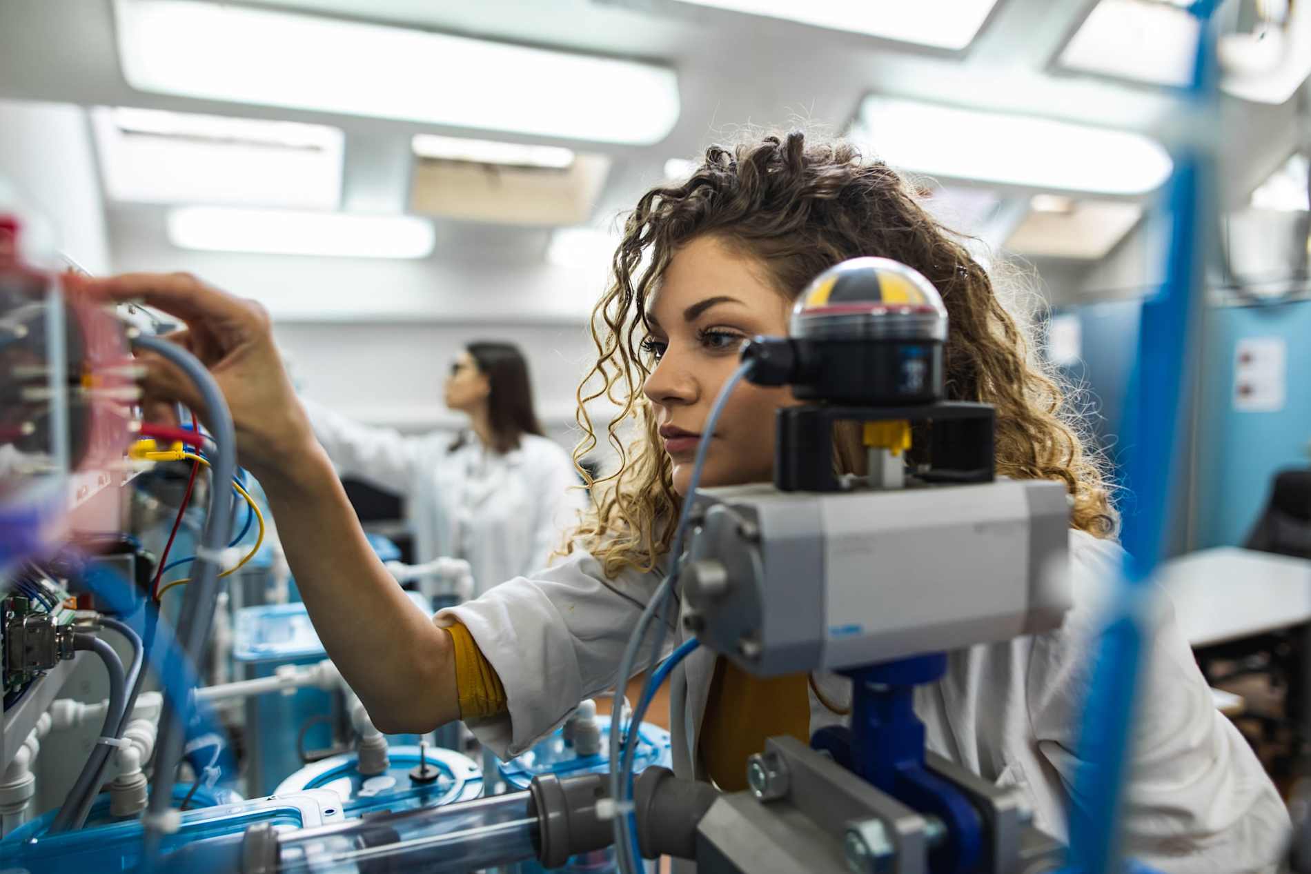 Young female engineer working in mechanical laboratory 