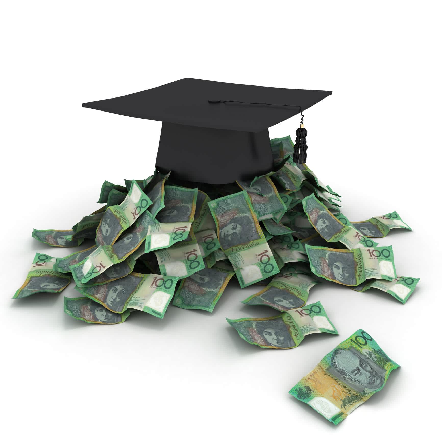Mortar board sitting on top of a pile of $100 bills.