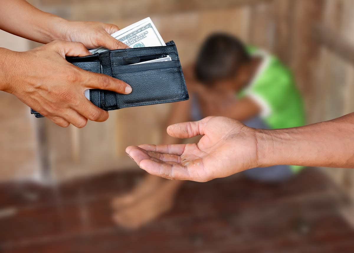 person handing over money to another person