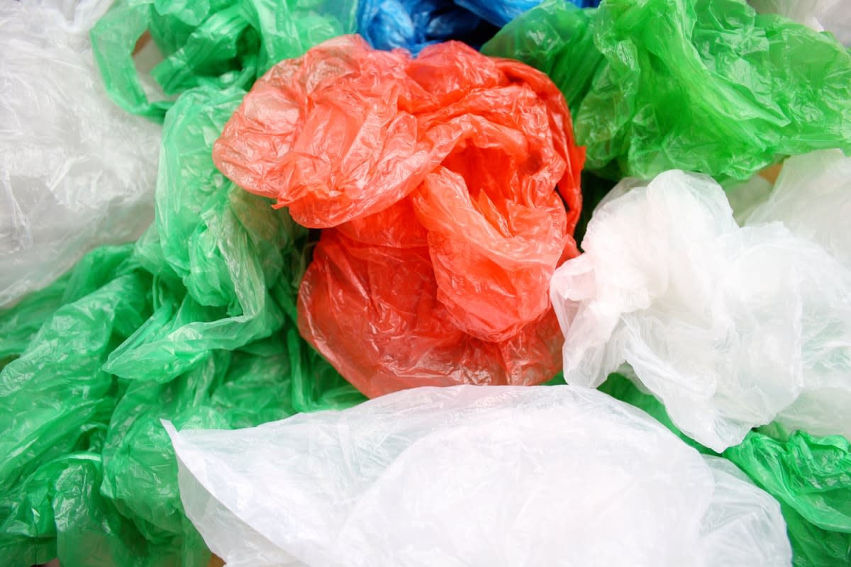 A pile of differently coloured single-use plastic bags