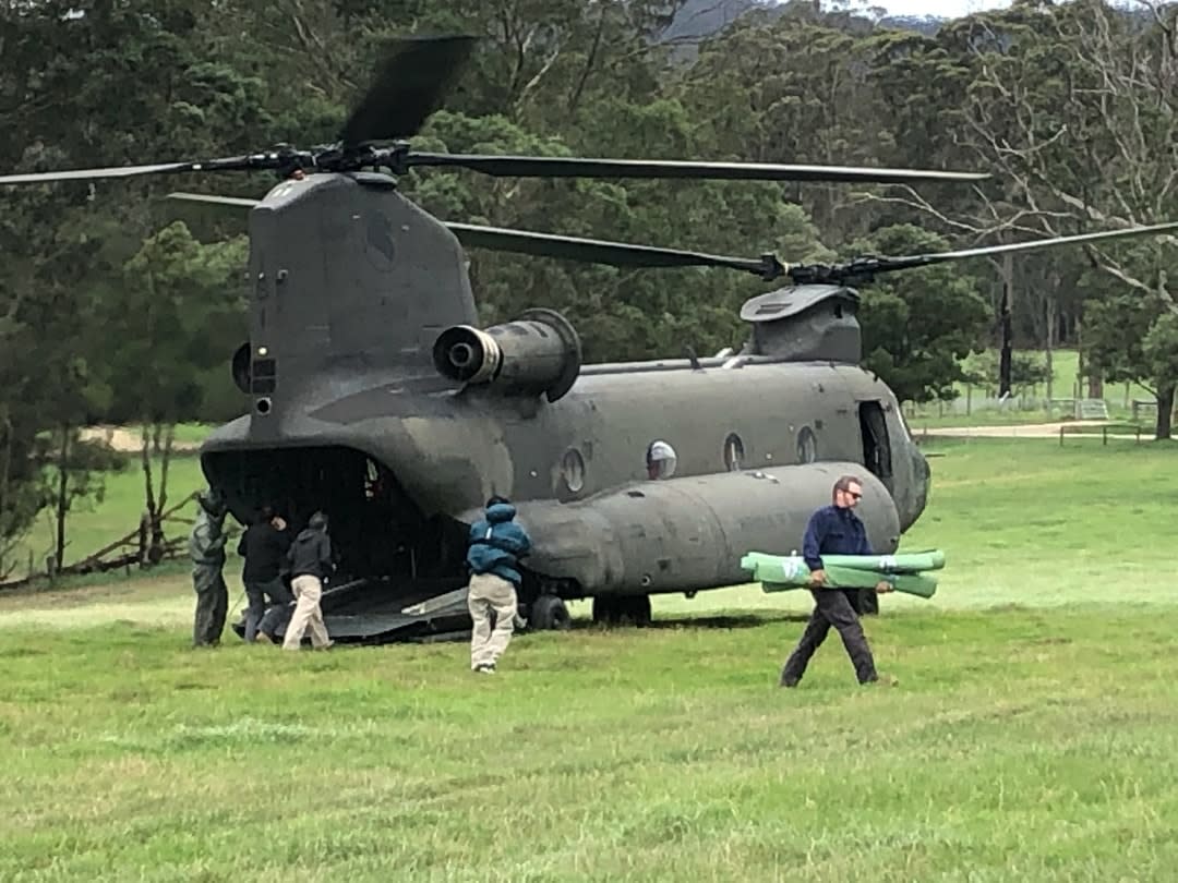 chinook helicopter with the team unloading equipment