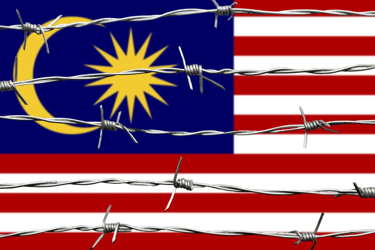 Malaysian flag with barbed wire over it