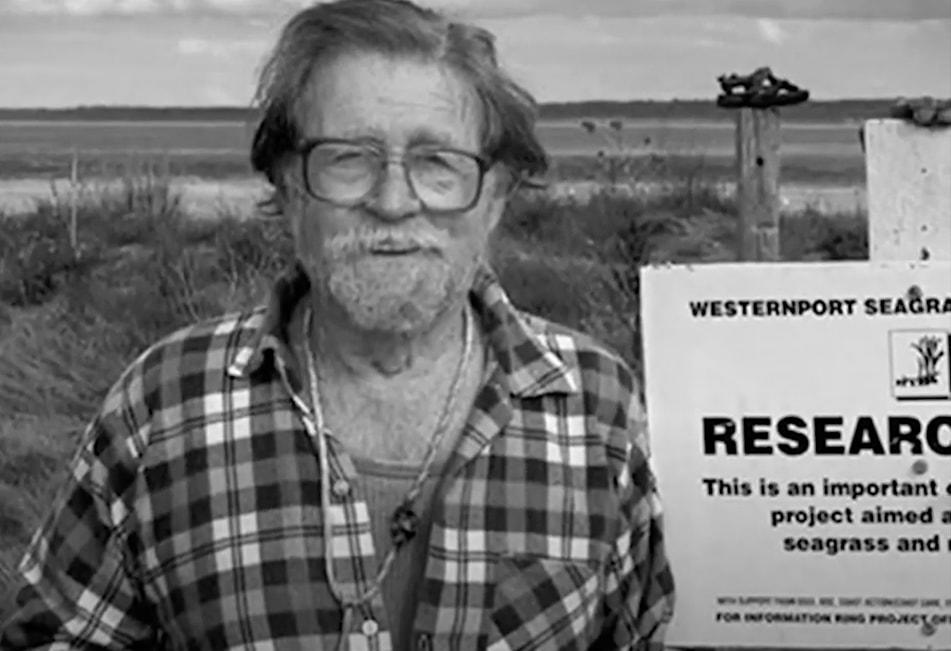 Dr Tim Ealey stands in fron of wetlands around Westernport Bay.