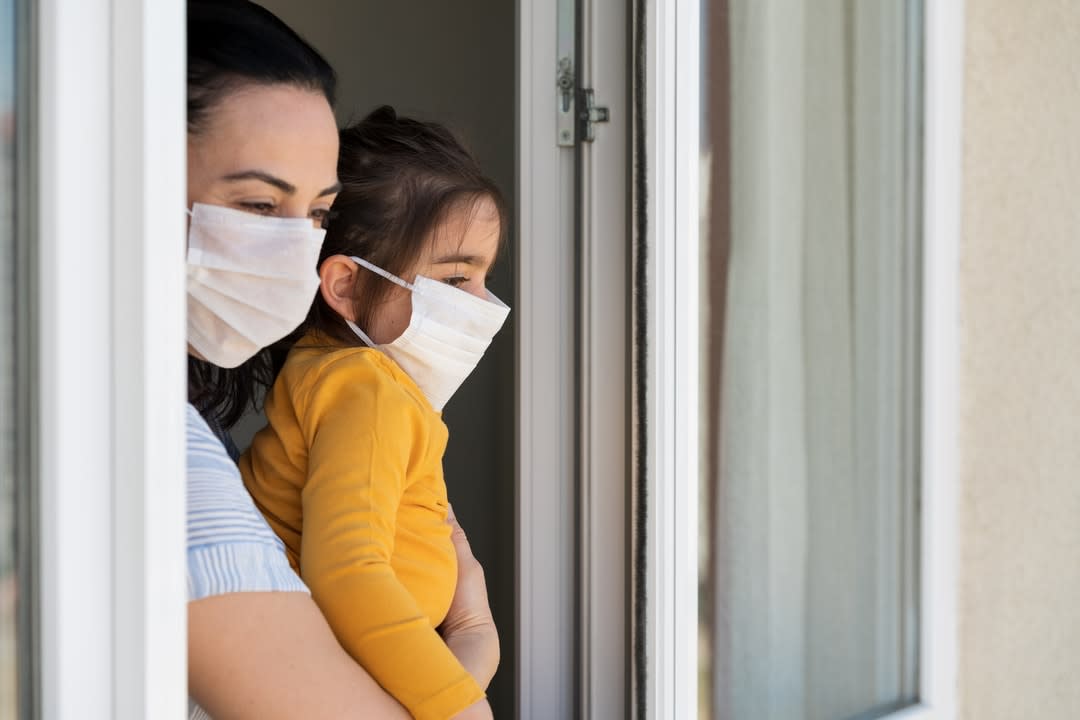 Mother and daughter wearing COVID-19 face masks