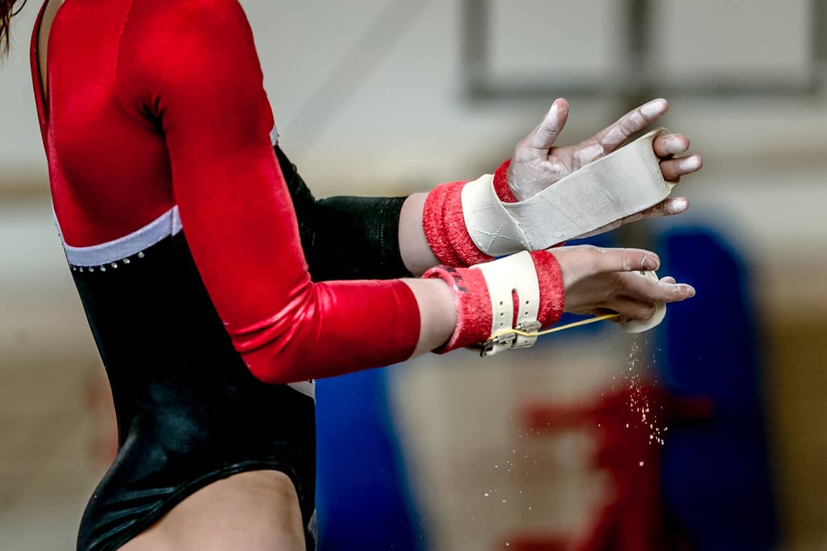 A female athlete's preparing her hands to compete 