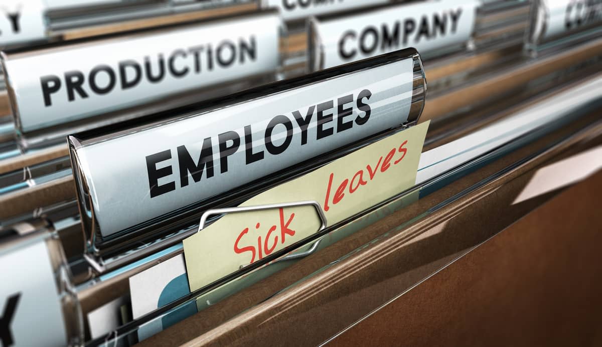 Files in a cabinet with labels reading ‘production‘, ‘employees‘, company‘, and ‘sick leave‘