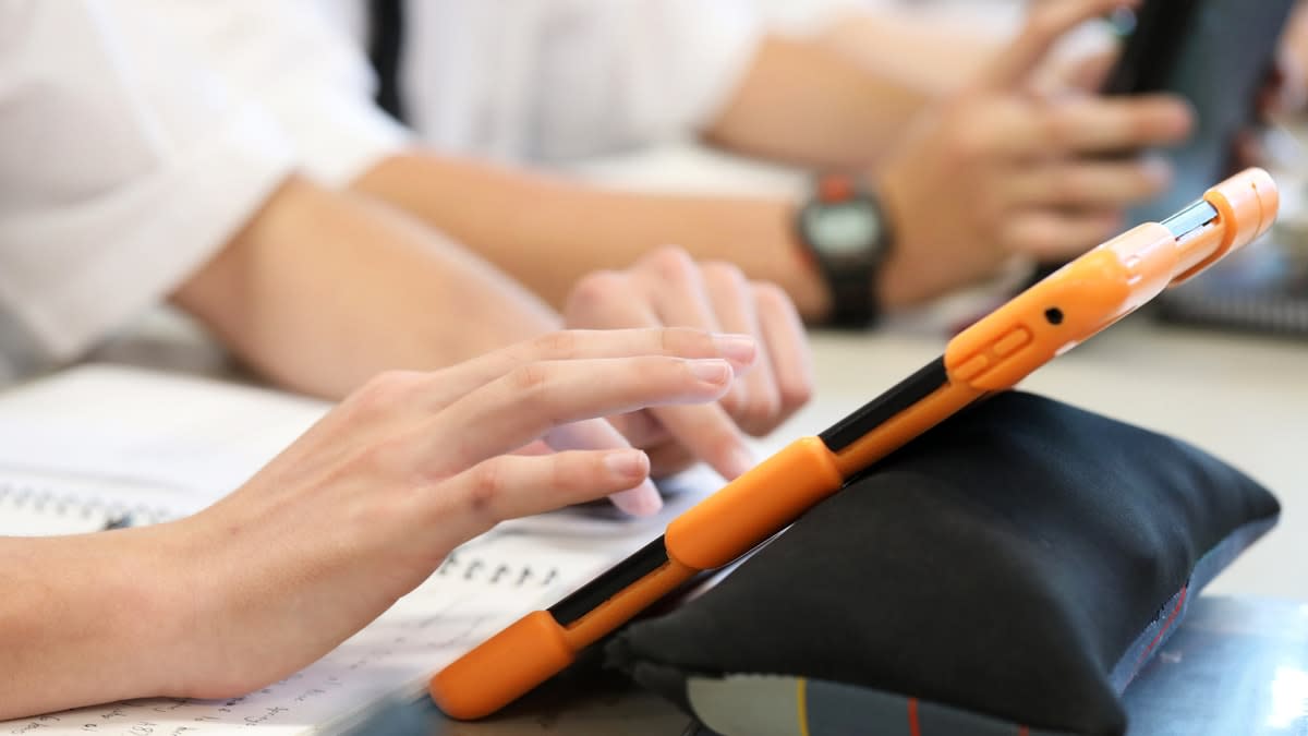 Close-up of a high school student working on an iPad