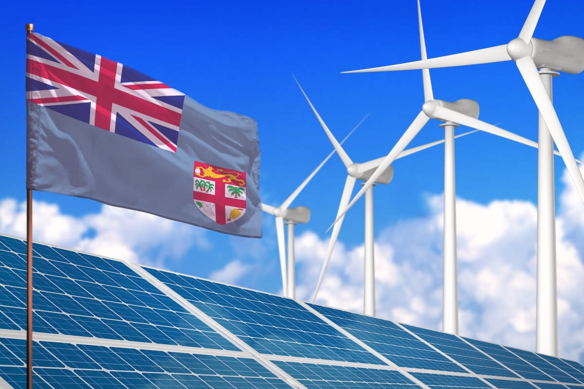 Composite image of a Fiji flag with solar panels and wind turbines.