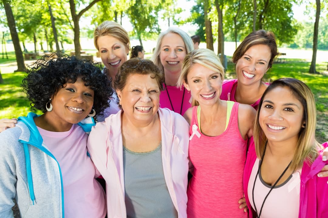 A group of women dressed in pink exercise gear.