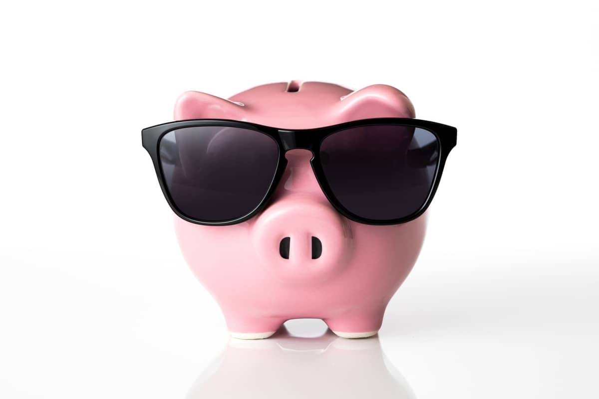 A pink piggy bank wearing dark sunglasses