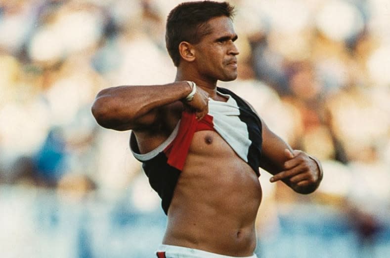 St Kilda footballer Nicky Winmar lifts his guernsey and points to his skin after being racially abused by Collingwood supporters in 1993.