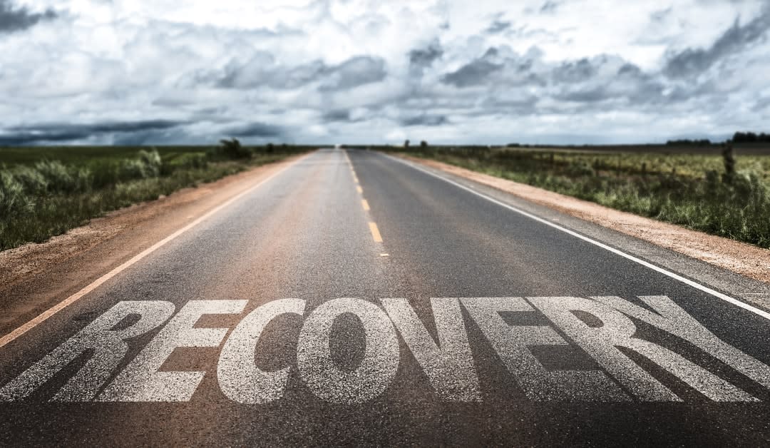 An open road with the word ‘recovery‘ painted on it