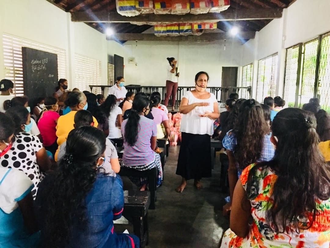 A woman from the Da Bindu Collective talks to a room of women from the garment industry in Sr Lanka.