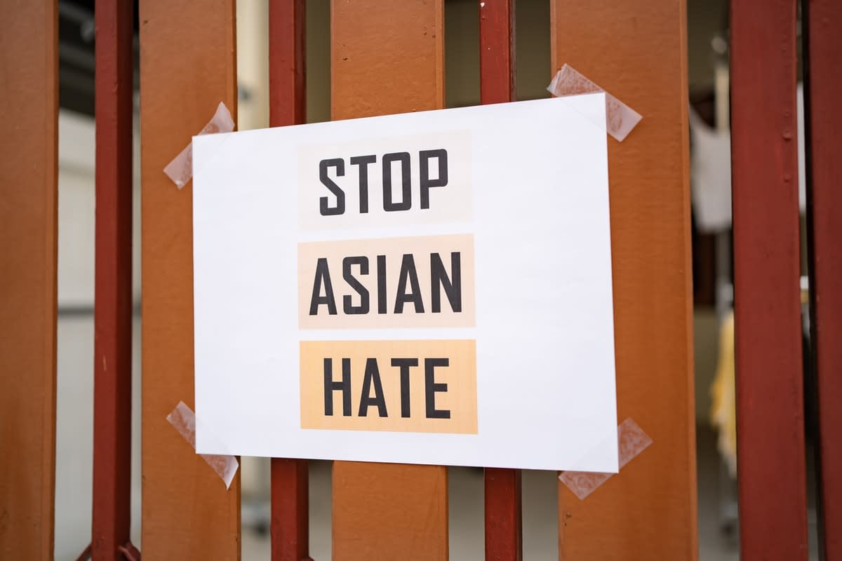 A sign taped to a fence reading ‘Stop Asian Hate‘