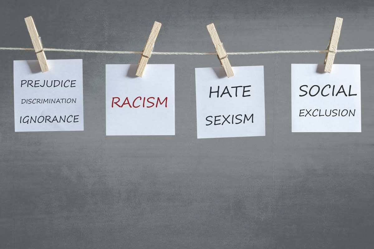 Notes pegged to a line, reading ‘Prejudice discrimination ignorance'; 'racism'; 'hate sexism'; 'social exclusion‘