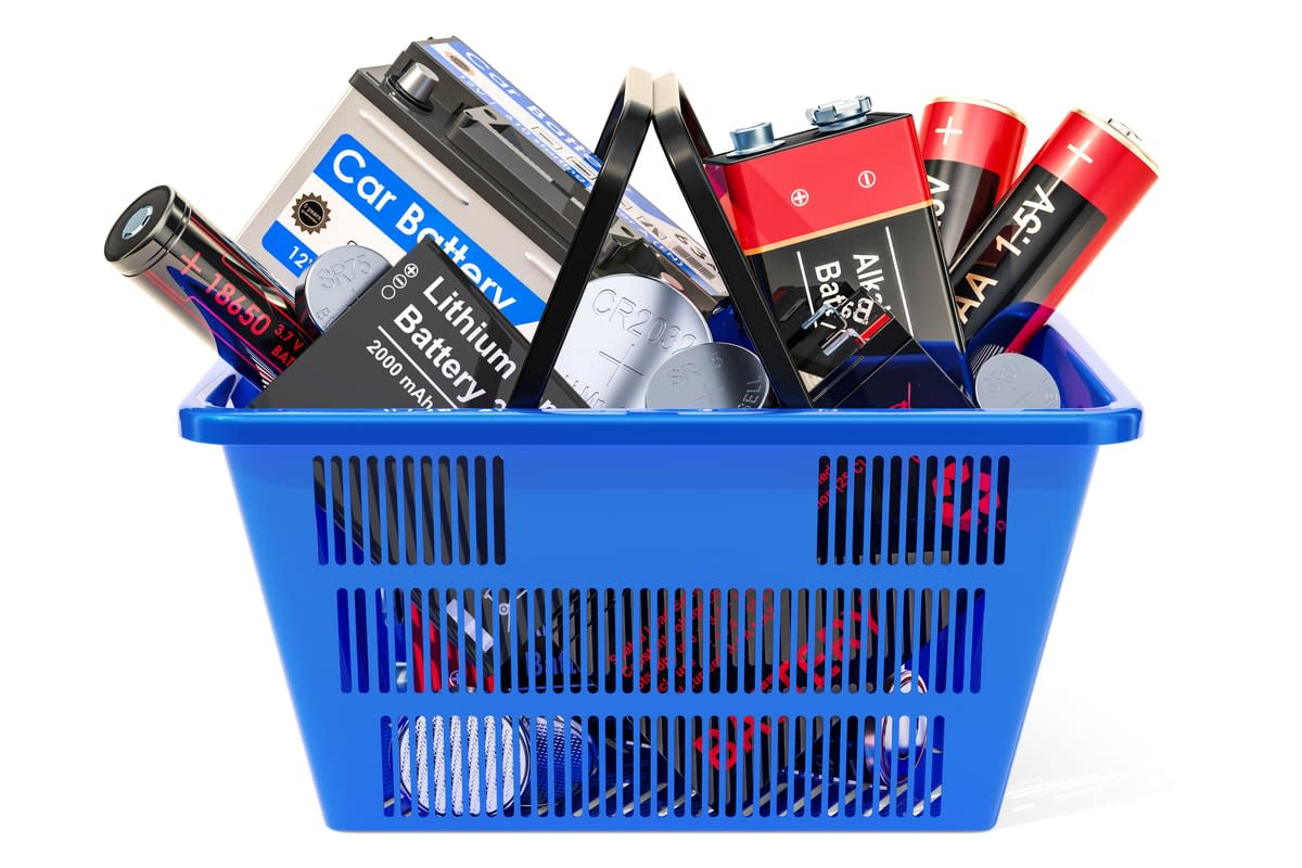 A shpping basket filled with various types of batteries