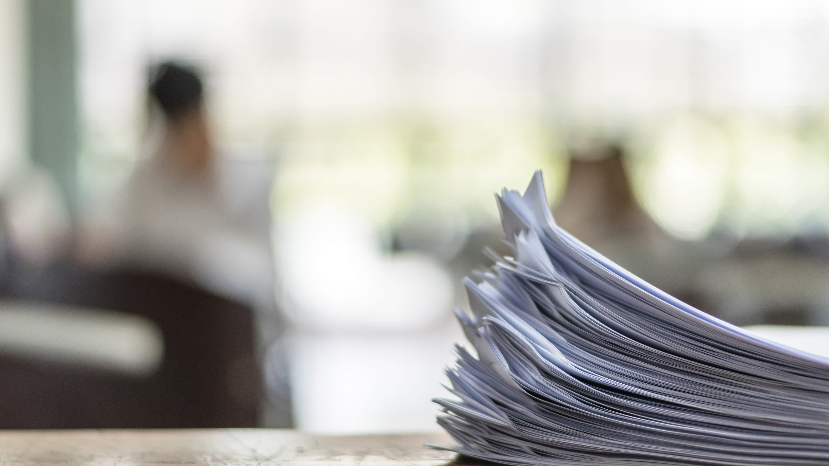 Close-up of exam paper sitting on a desk, with a blurred background