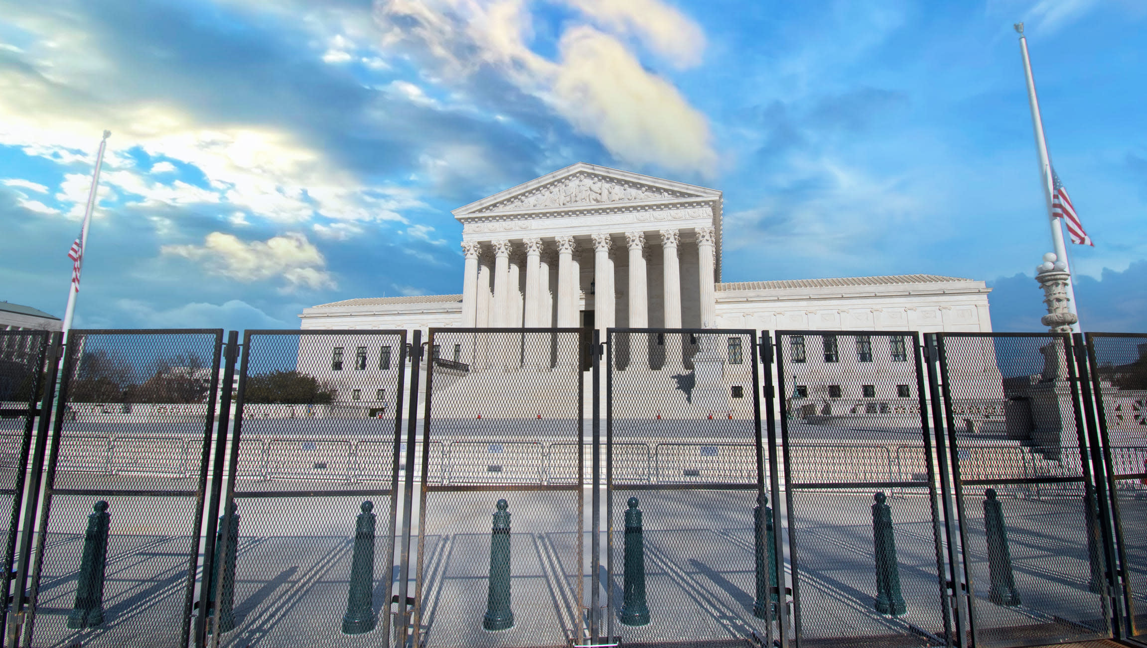 Exterior of the US Supreme Court building with barricade fences in the foreground