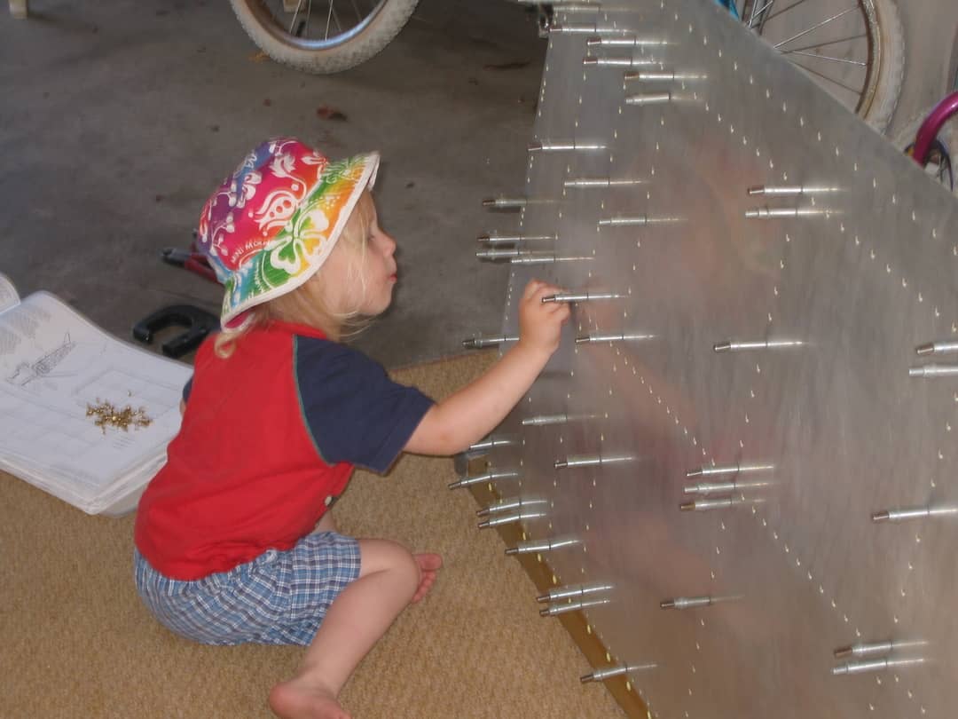 One of Jeffrey Walker's children helps build an aeroplane..