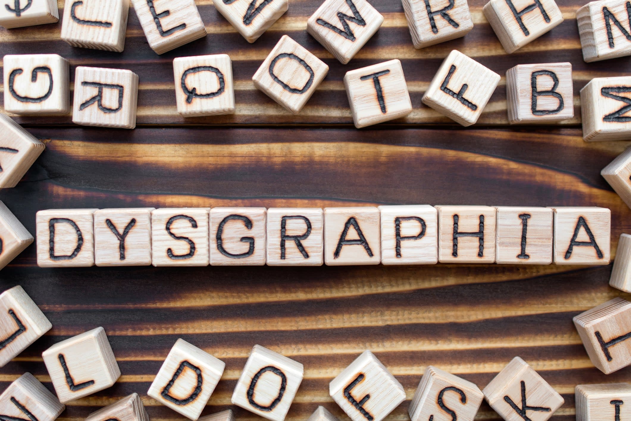 Wooden cubes with letters, spelling out 'dysgraphia'