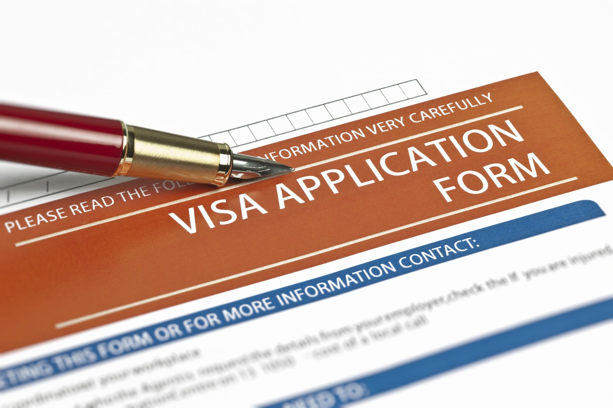 Close-up of a visa application form and pen