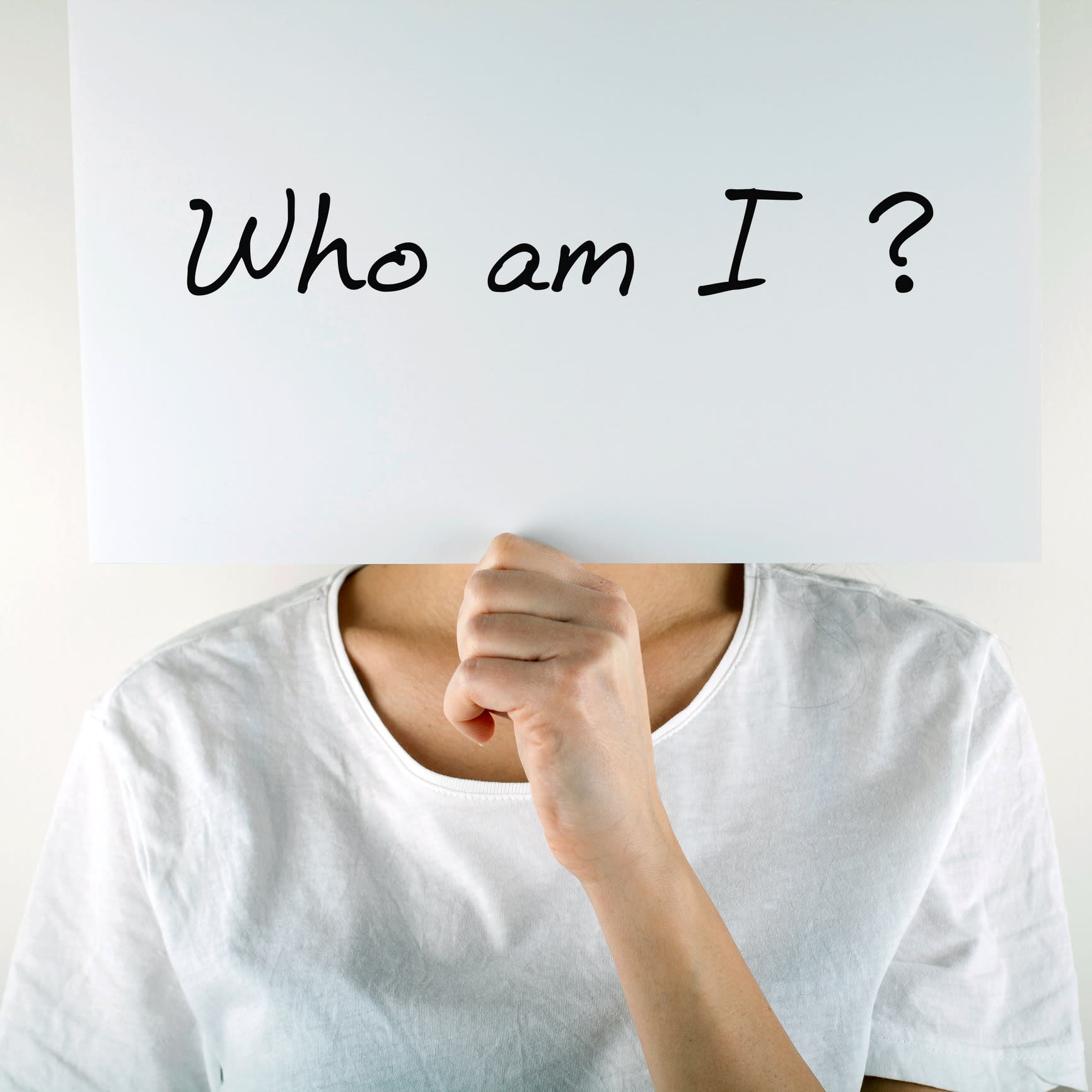 Unknown anonymous woman in yellow casual style t-shirt covering her face with white mask