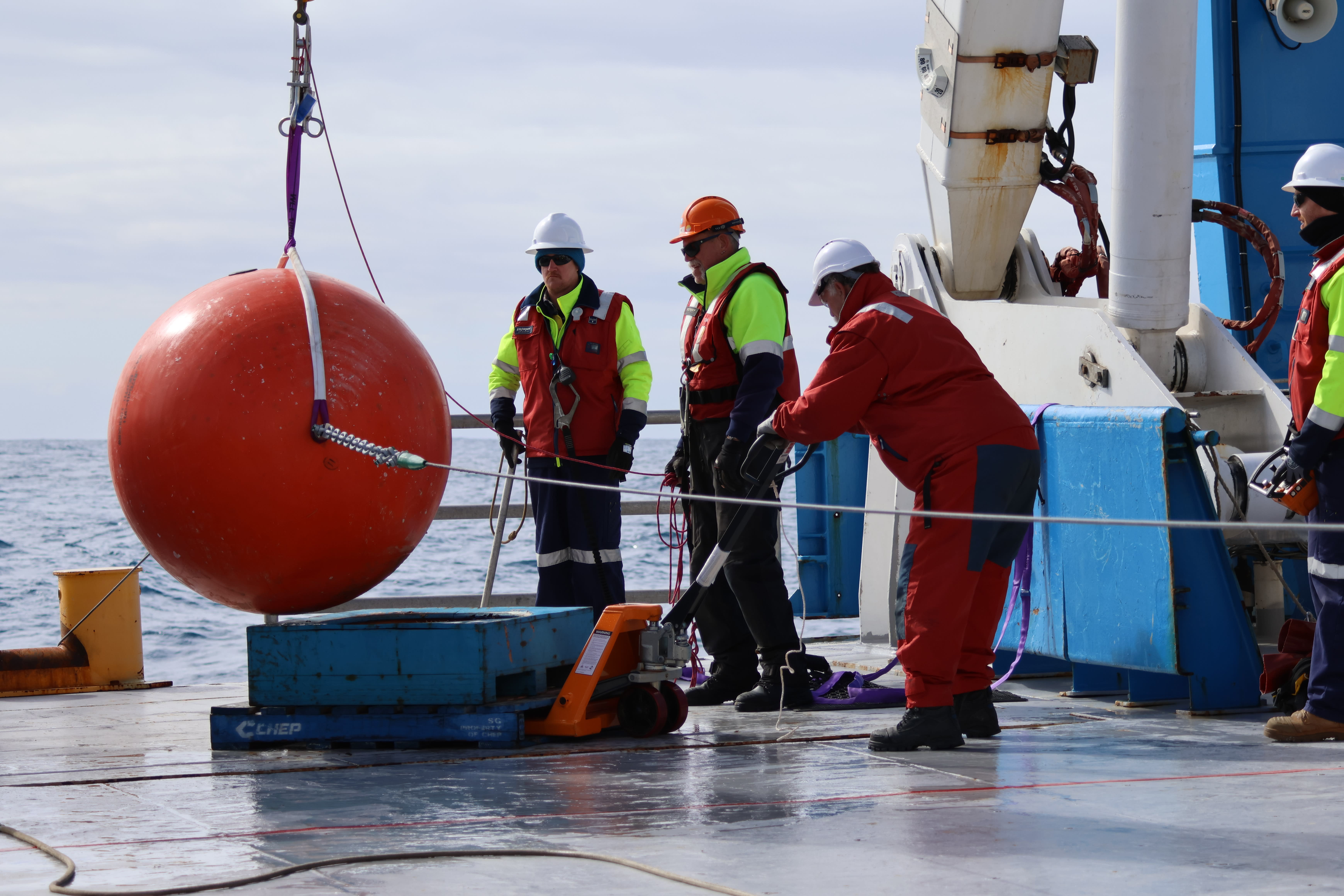 Tall mooring float deployment by scientists on board the RV Investigator ship.