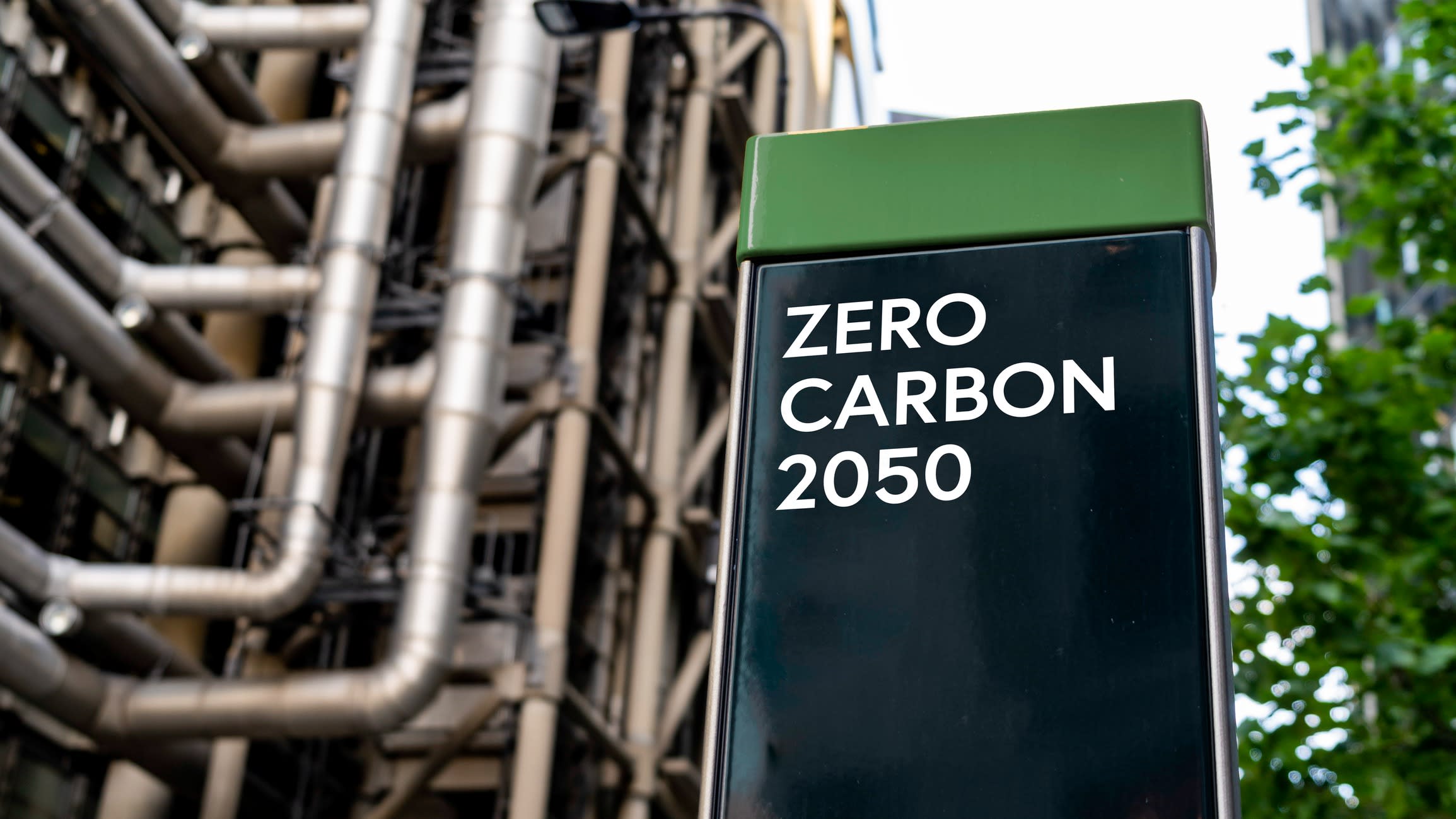 Zero Carbon 2050 on a sign in front of an Industrial building