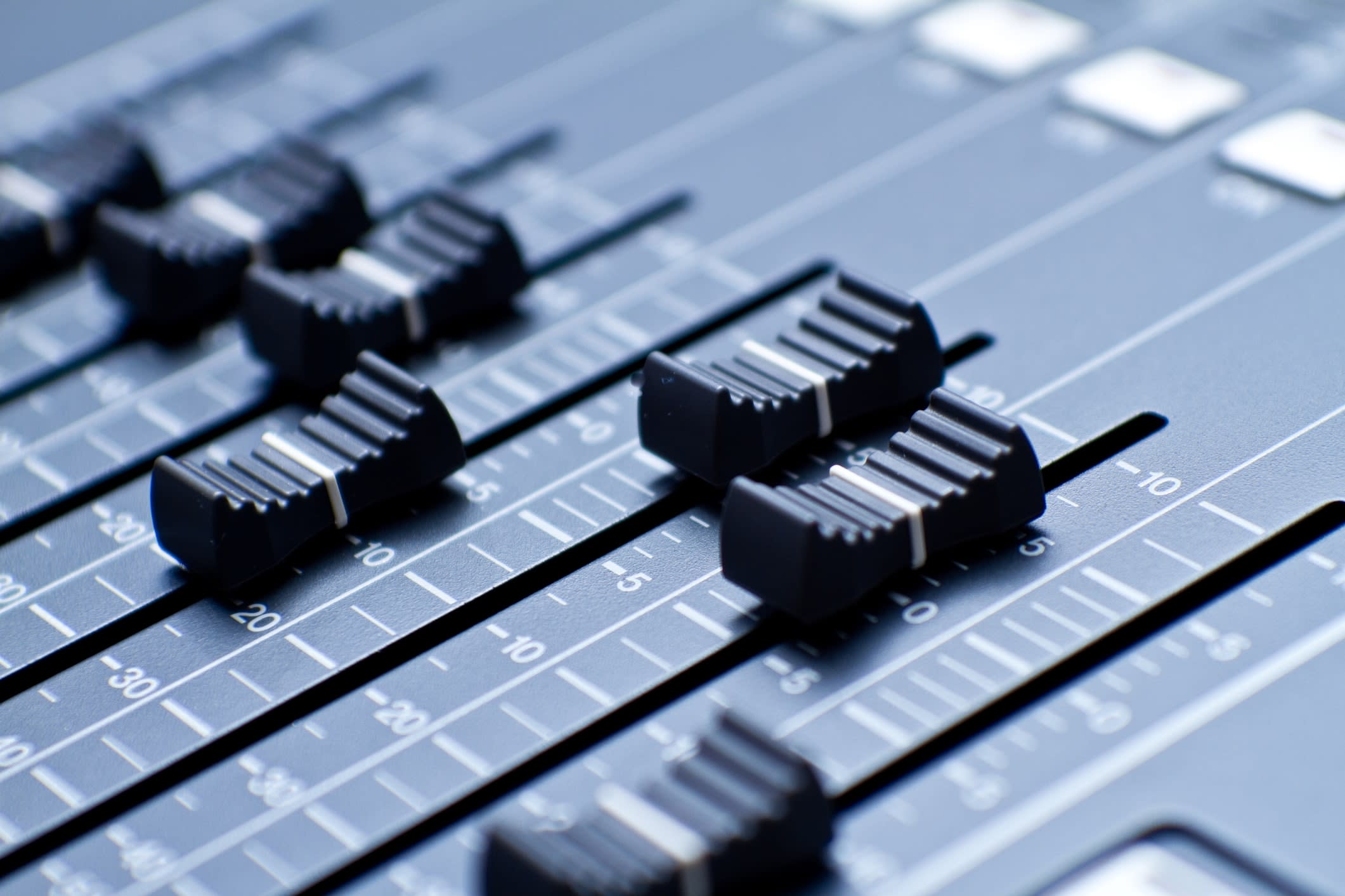 Close-up of sliders on a digital sound console