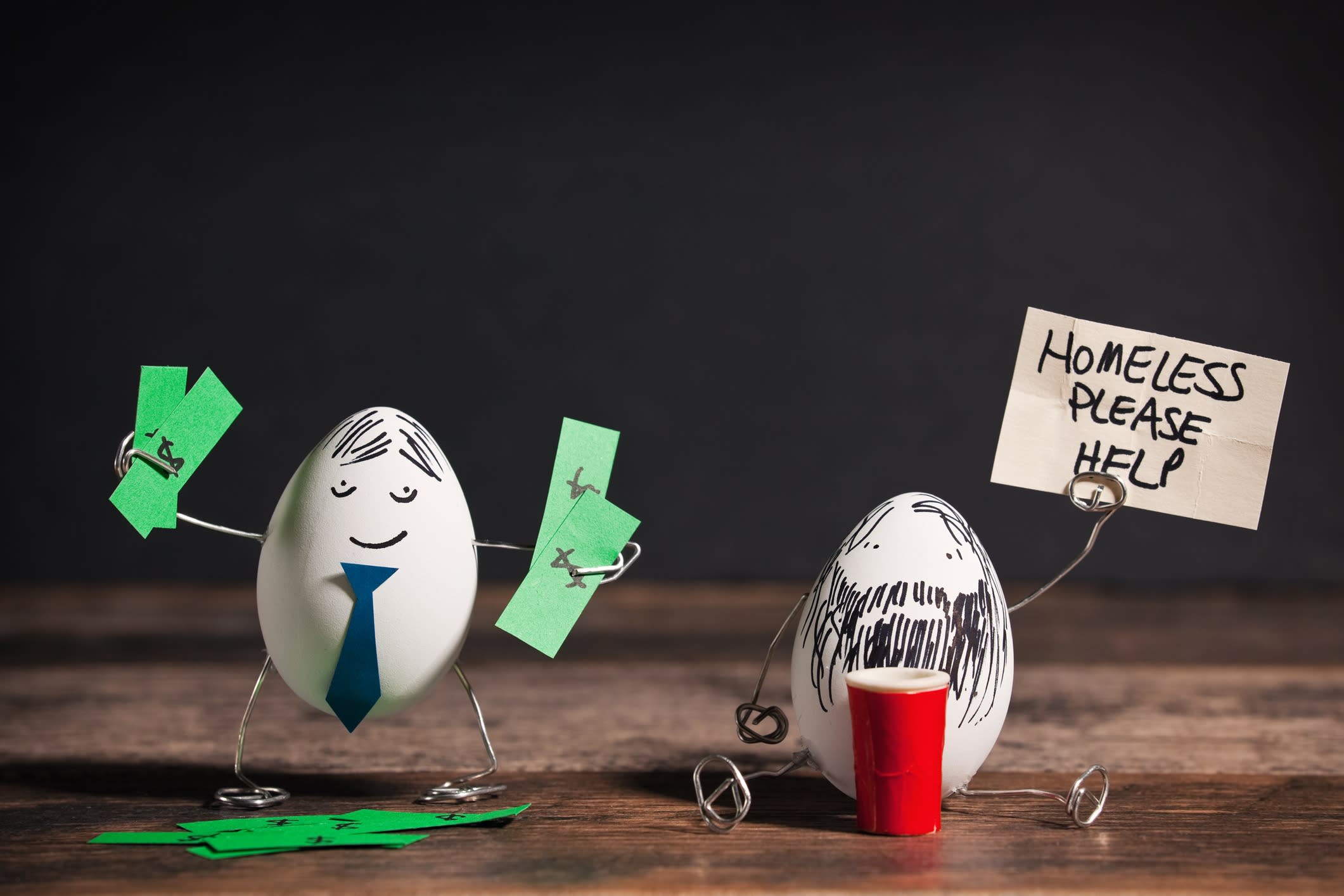 Egg characters dressed as a rich business man and a homeless man