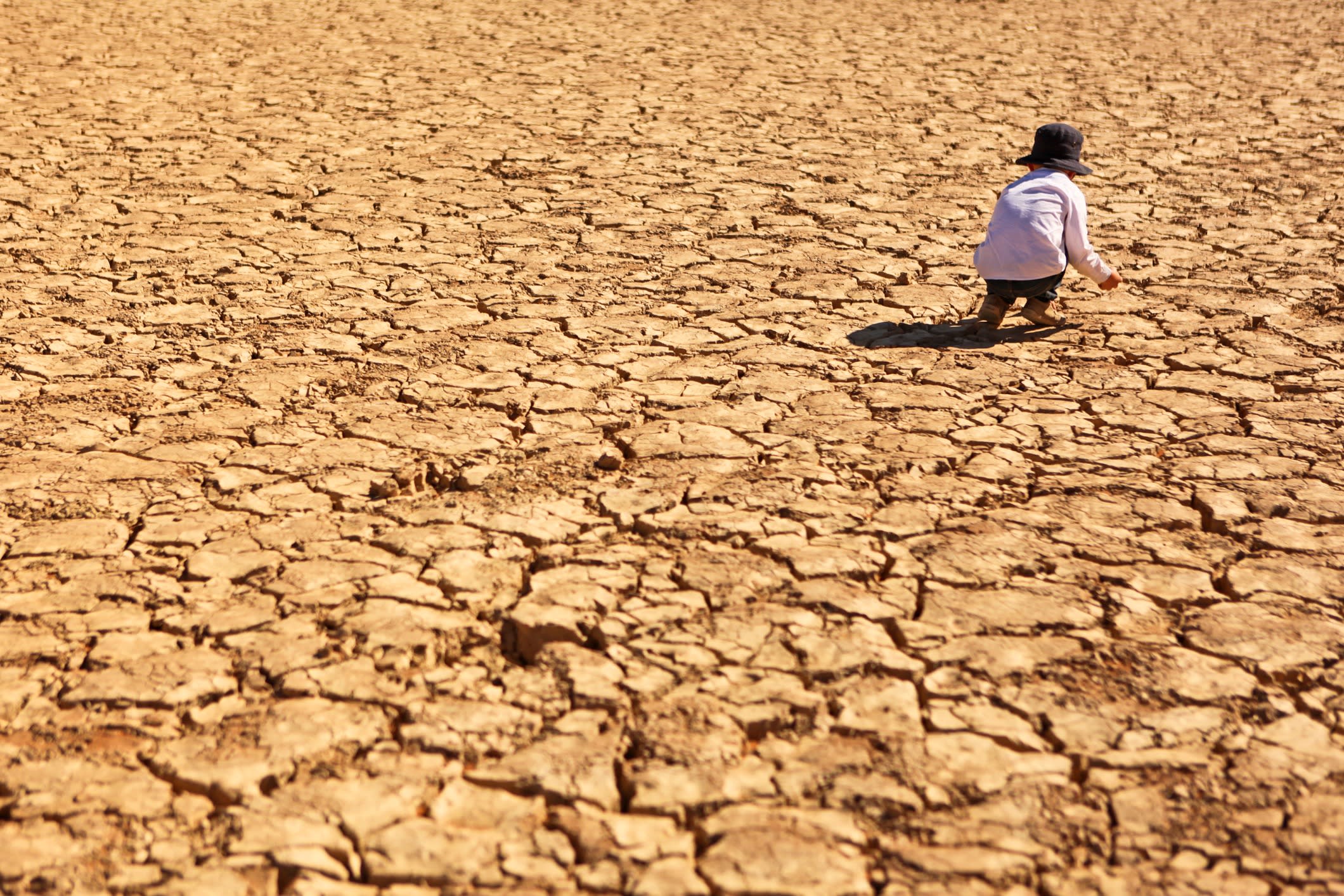 Child Playing on Dry Parched Desert Land