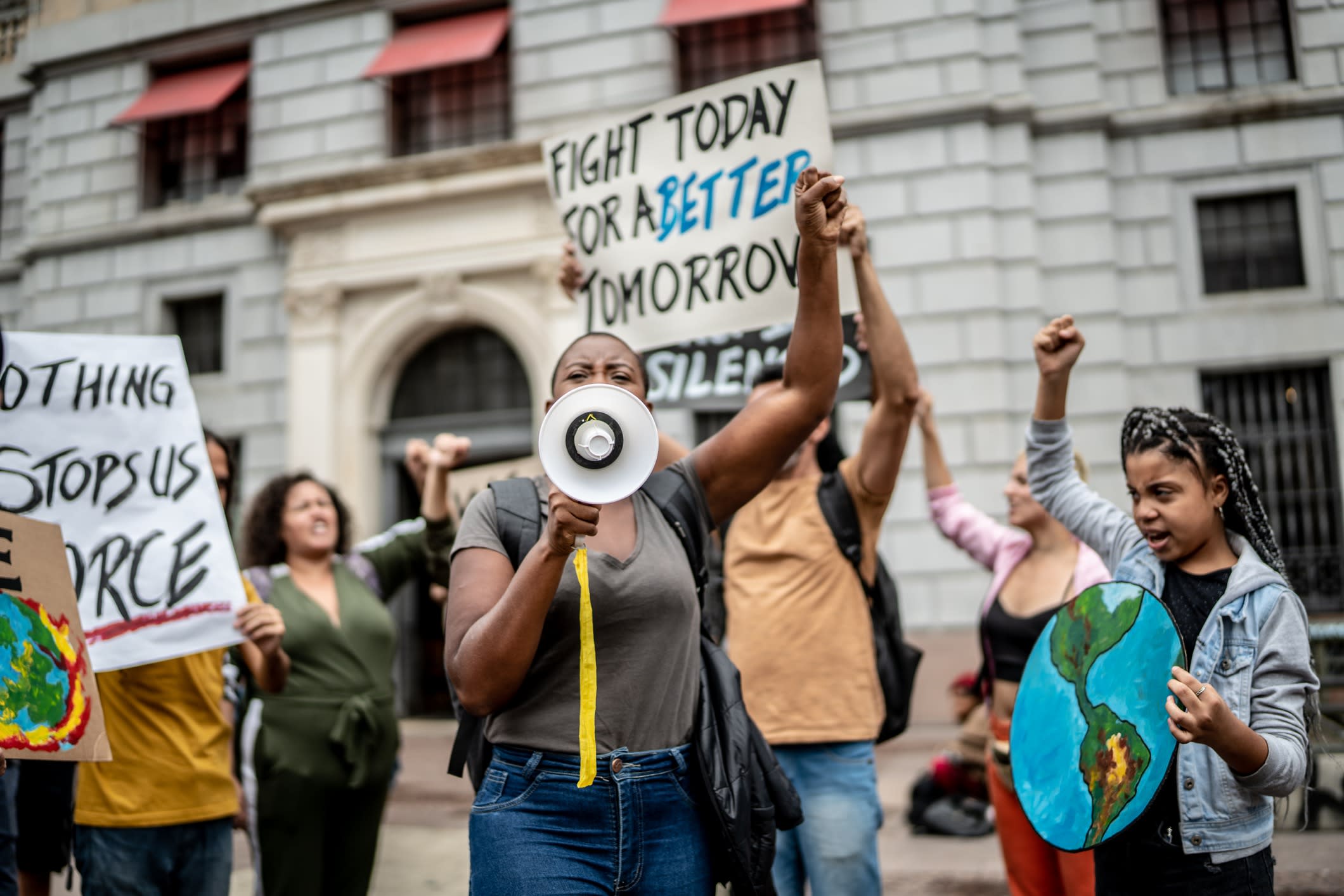 Protests holding signs during on a demonstration, including young girl