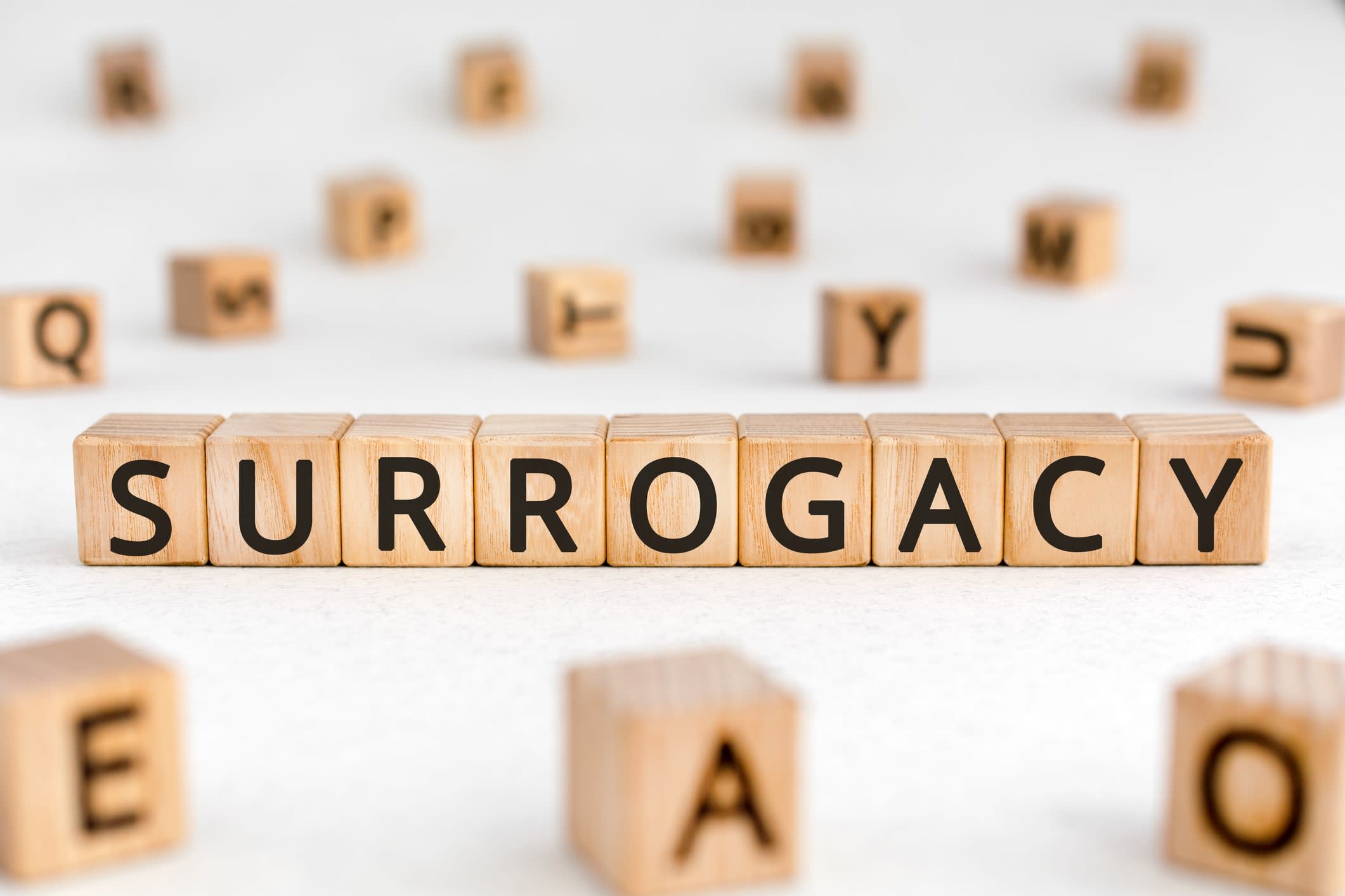 The word 'Surrogacy' spelt out in wooden blocks
