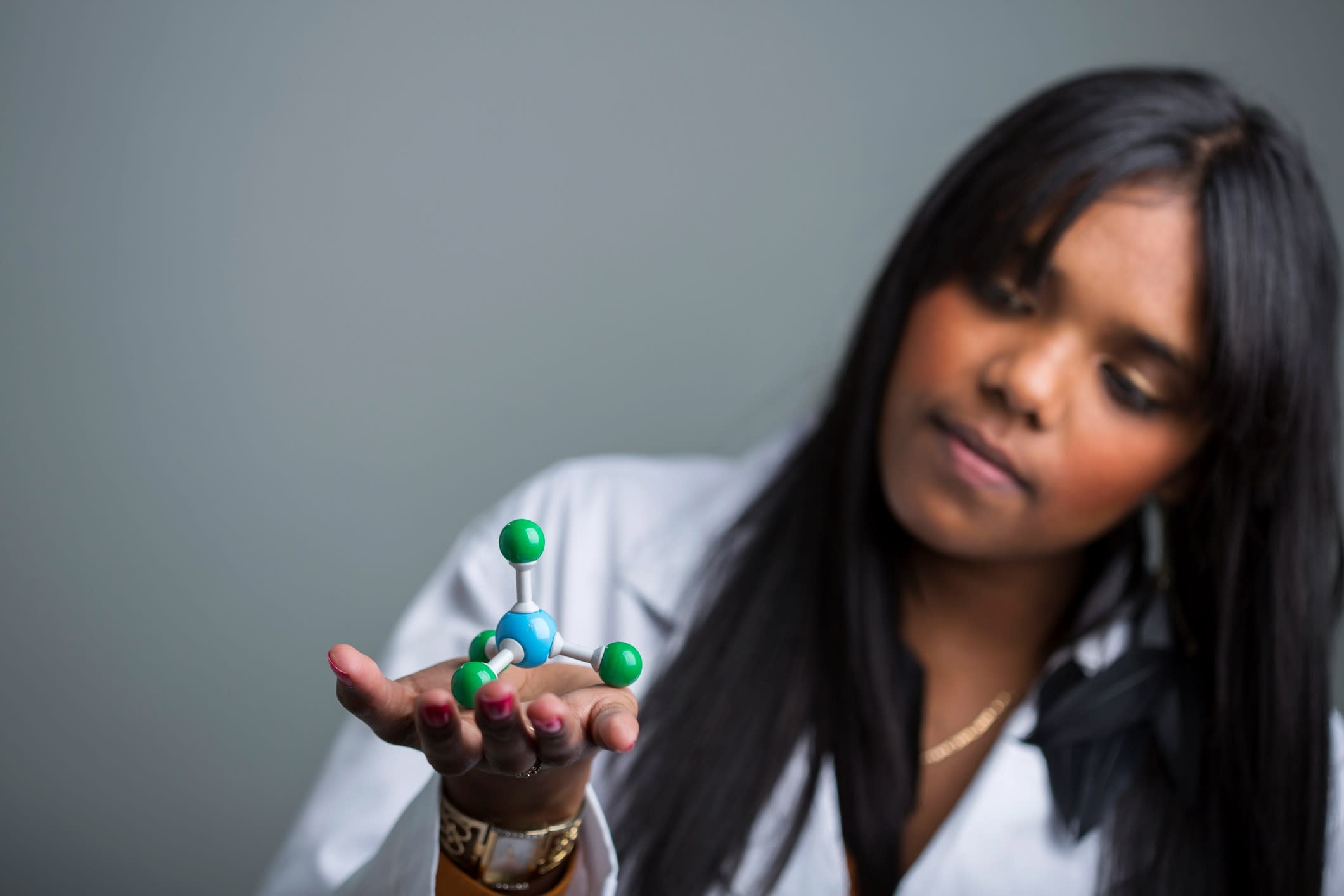 Indigenous Australian scientist with a molecular model