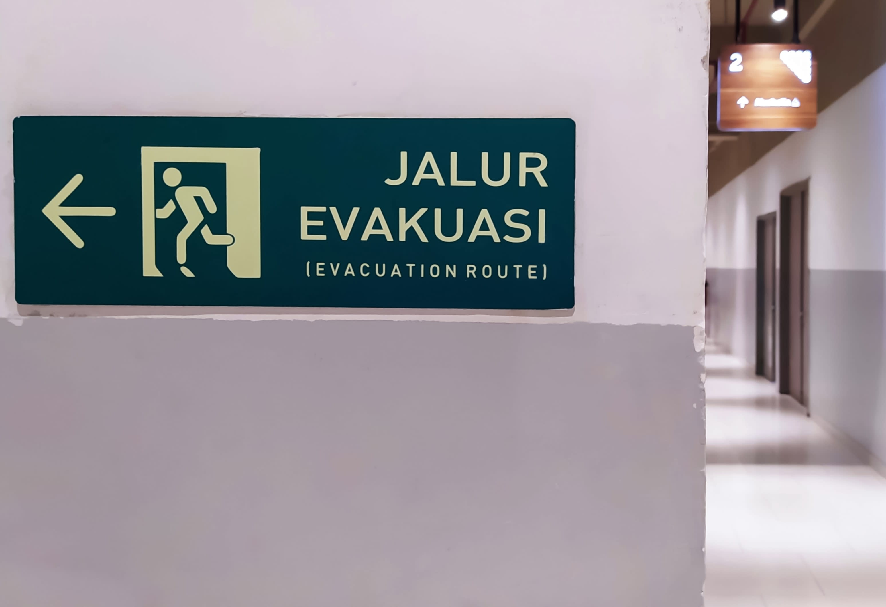 Indonesian evacuation route sign in a building