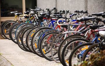 A number of bikes parked next to one another