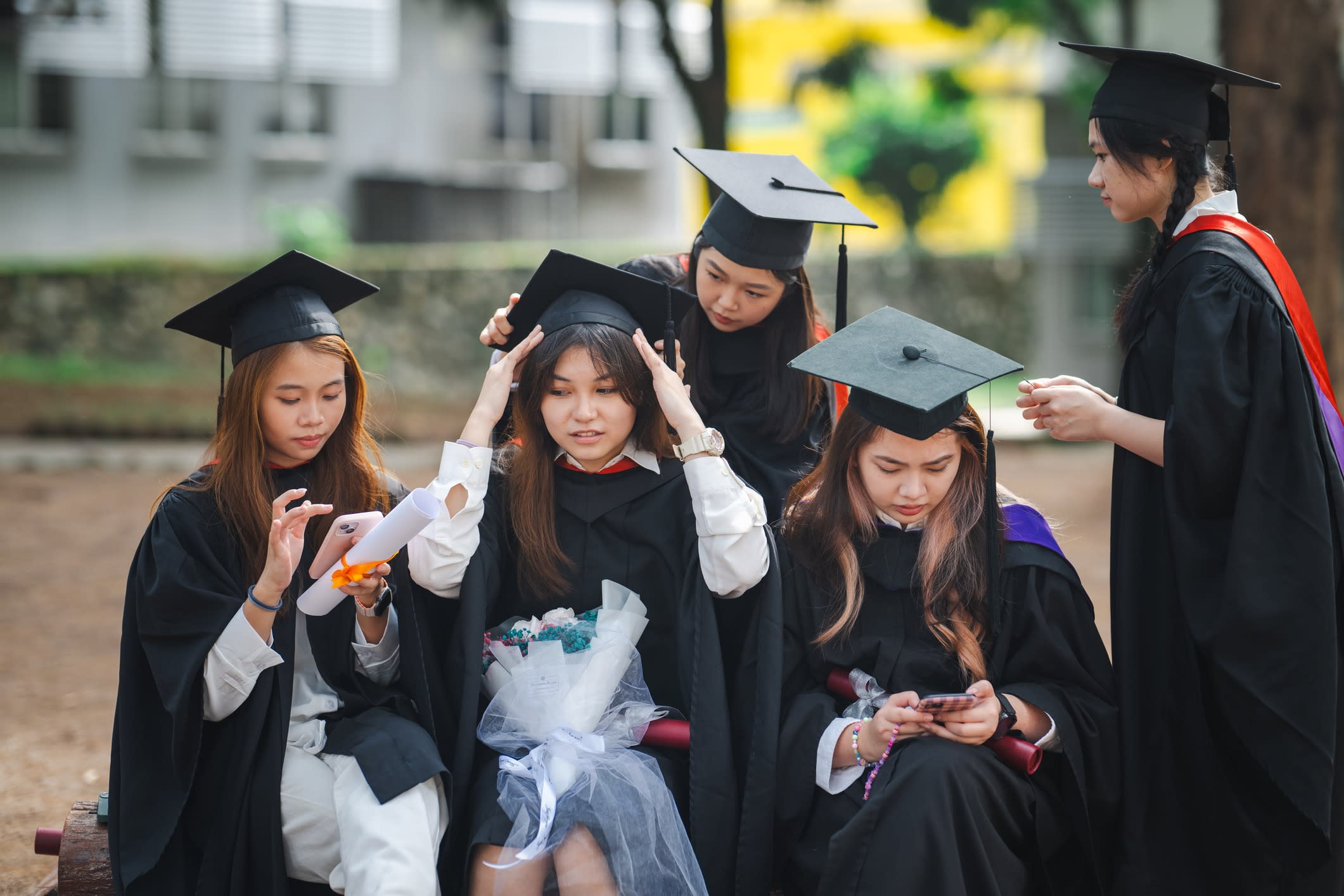 A group of Asian students graduating.