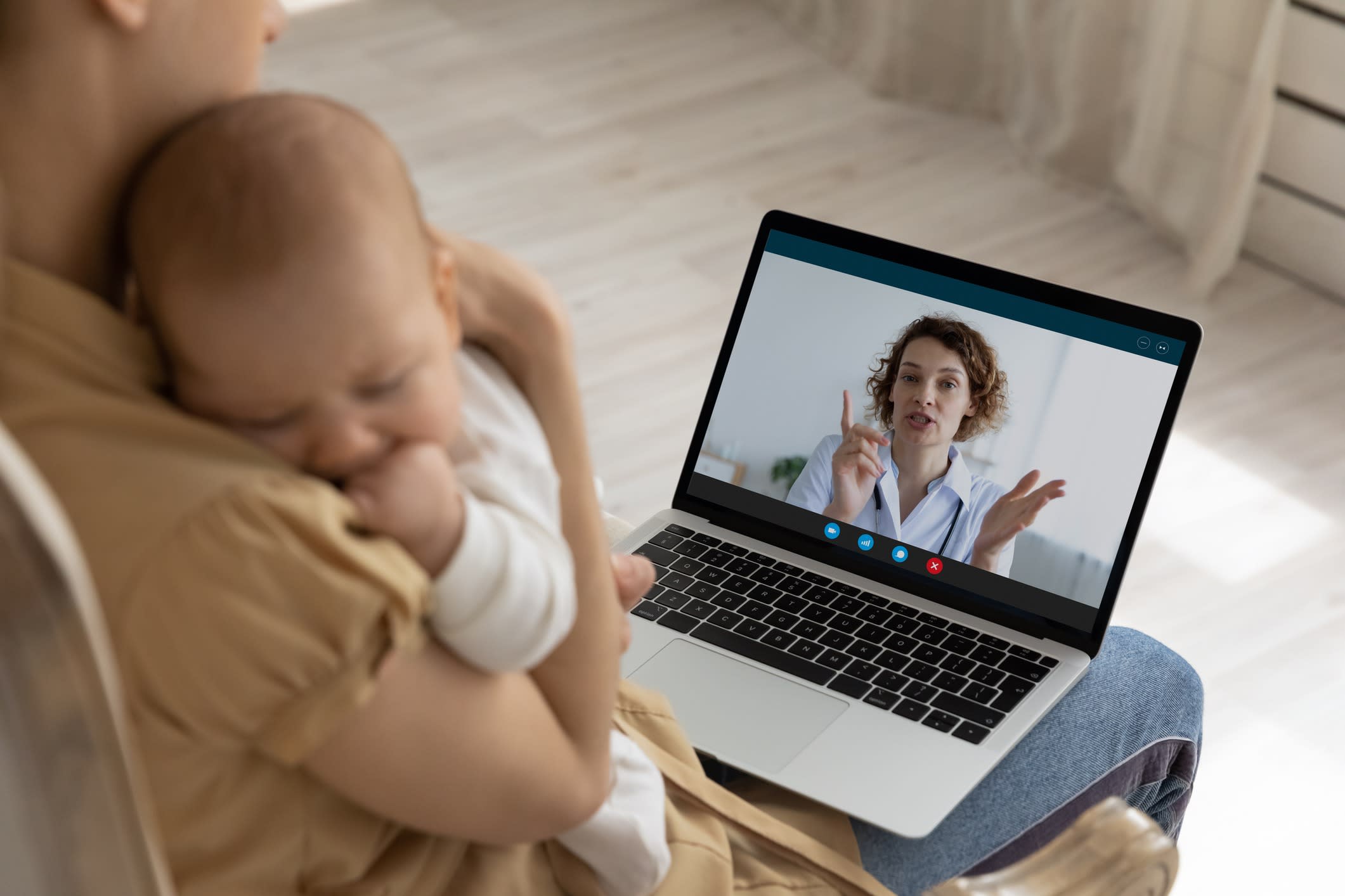 New mother with baby on a telehealth call.