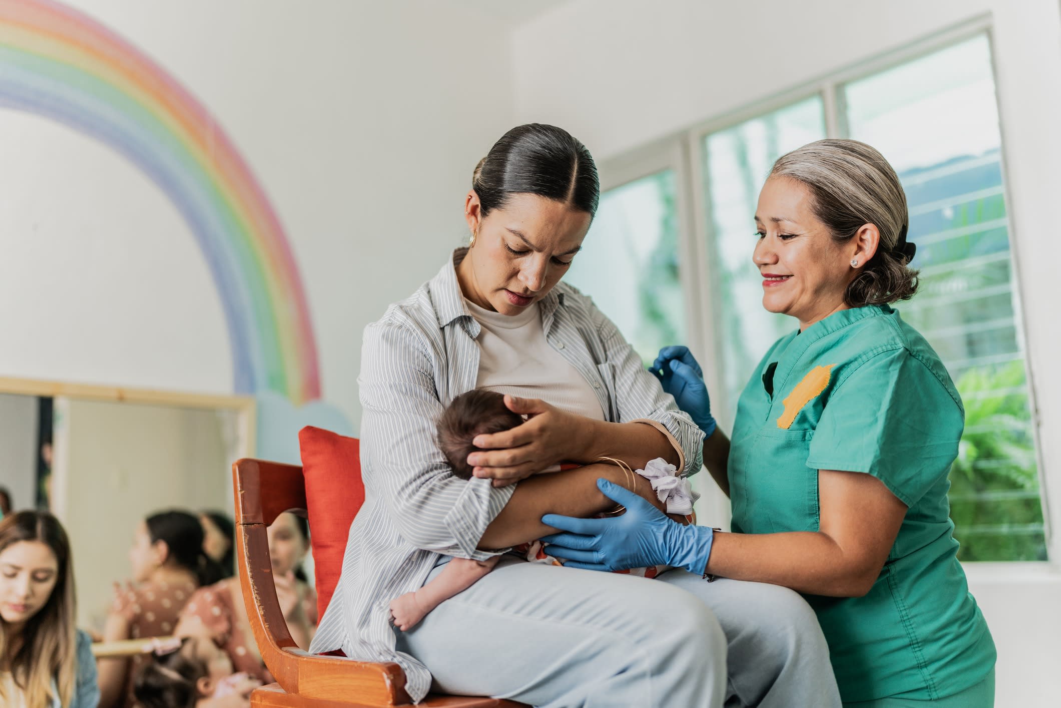 Healthcare professional helping a new mother.