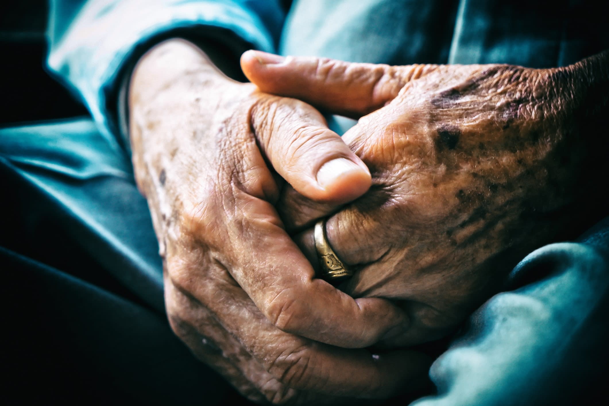 Close-up of an elderly man's clasped hands 