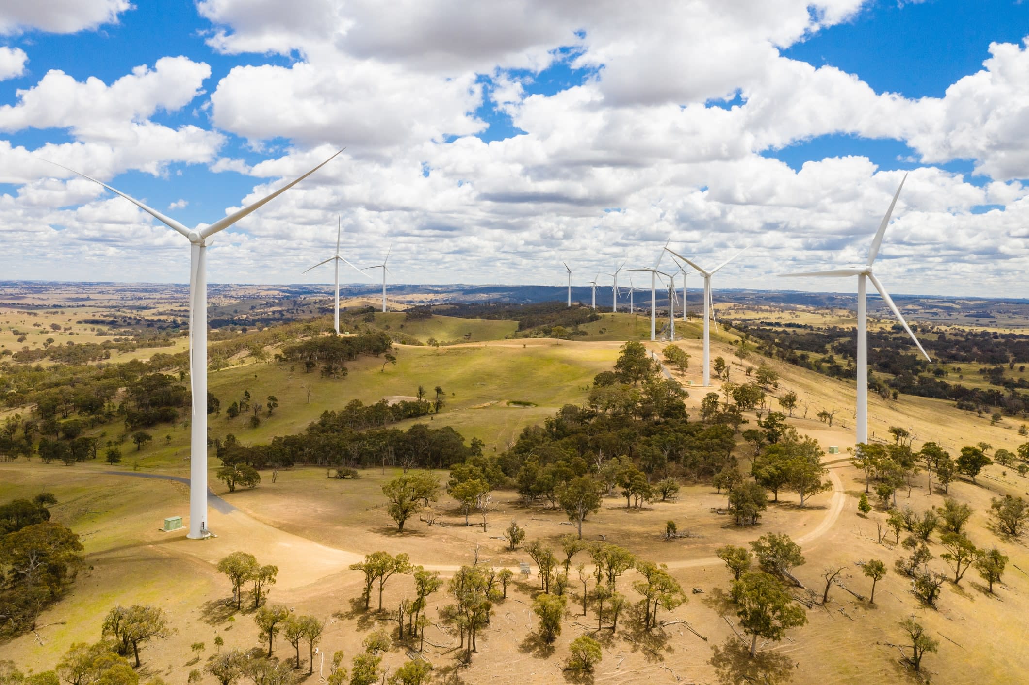 Wind turbines sitting on rolling hills