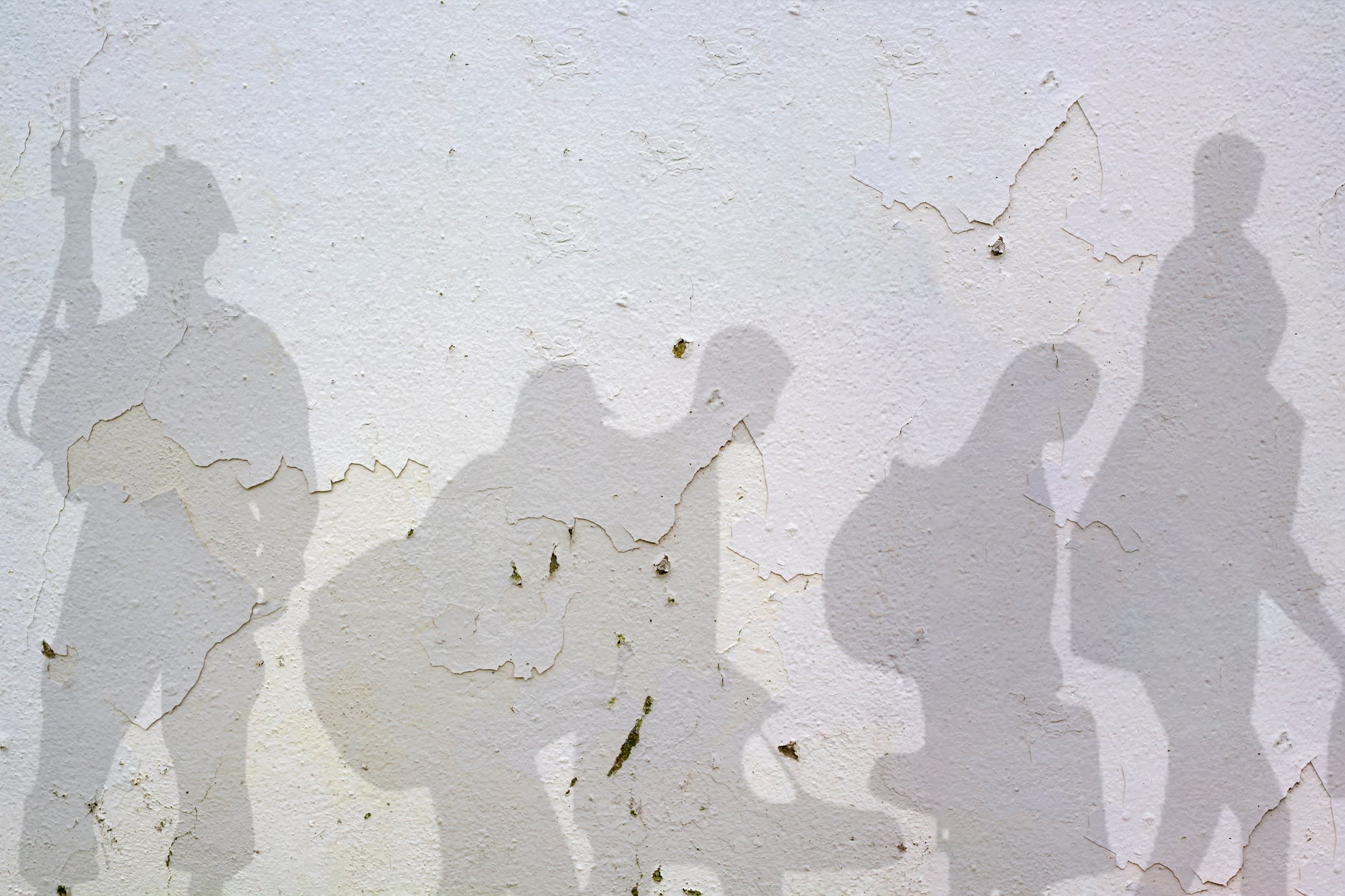 Soldier and Refugee shadows on wall