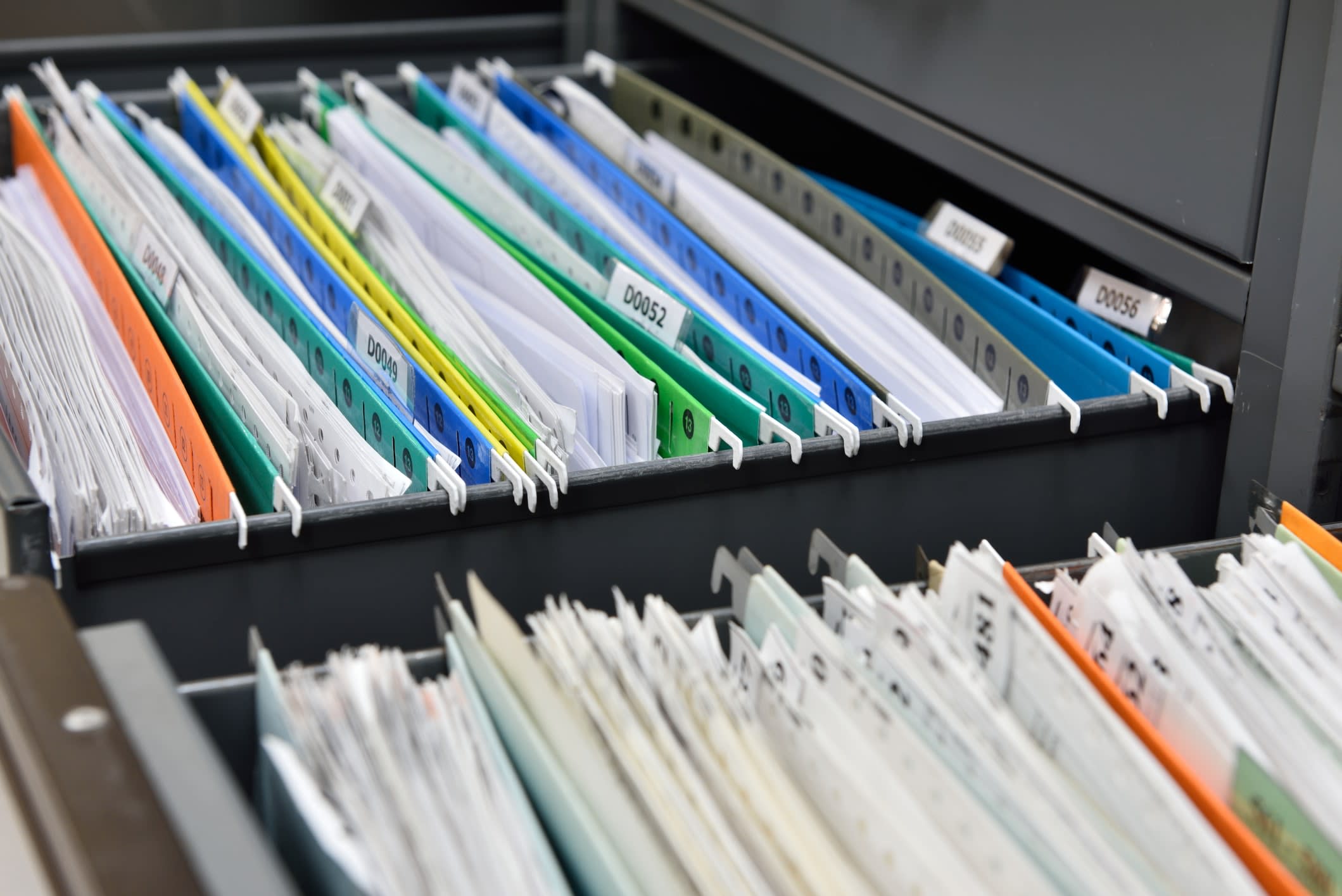 Files in open filing cabinet drawers