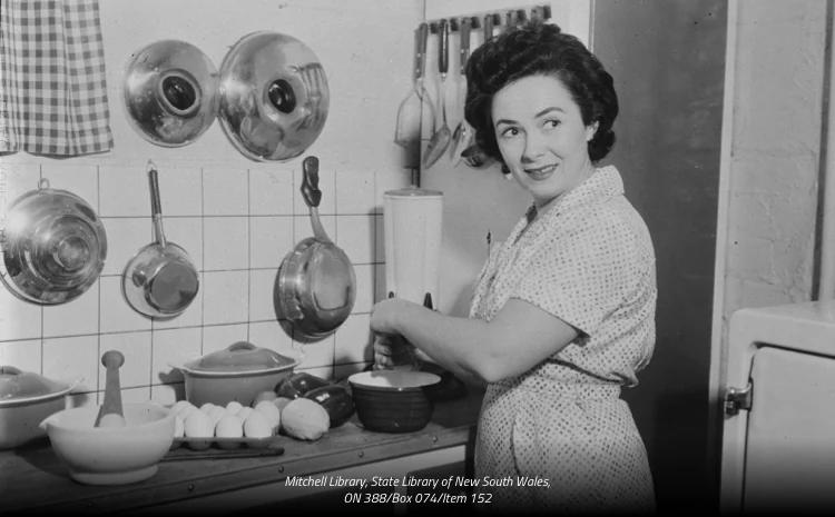 Black and white photo of Margaret Fulton cooking in a kitchen.
