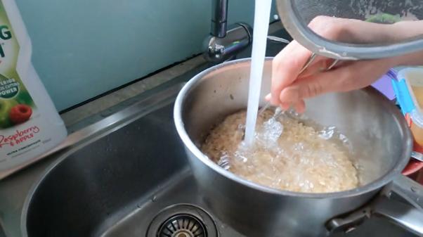 Washing rice in a sink. 