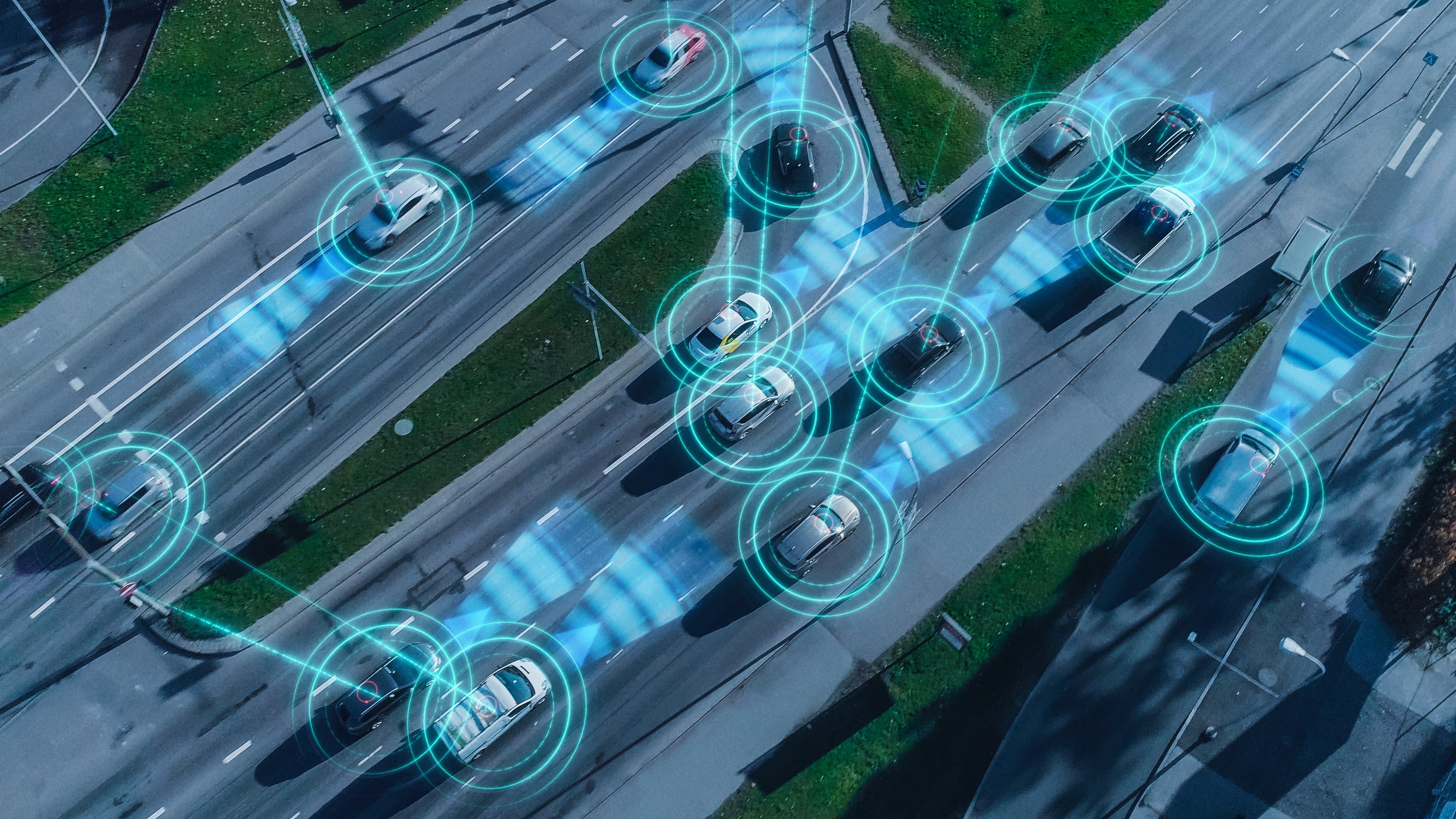 Top-down stylised image of an aerial drone over autonomous self-driving cars moving through a city.