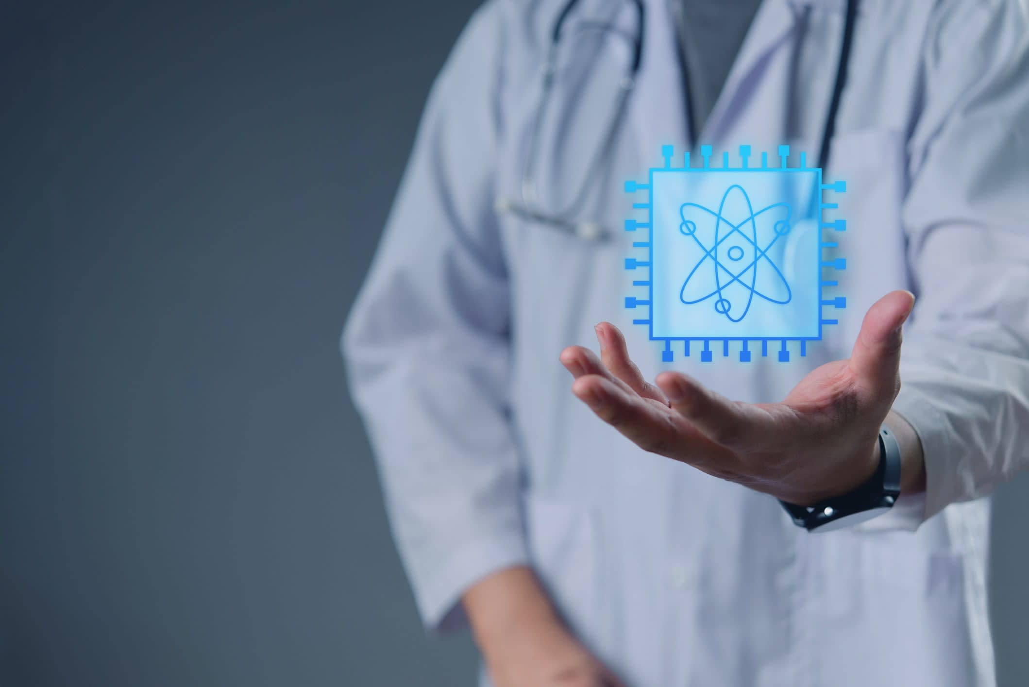 Doctor in lab coat presenting a futuristic digital chip with atom icon, symbolizing innovation in medical technology