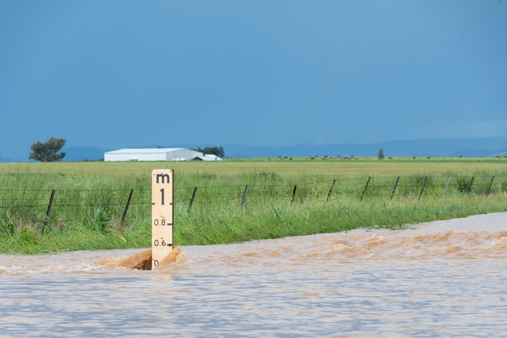 Flood depth indicator in deep fast-flowing floodwater showing water depth