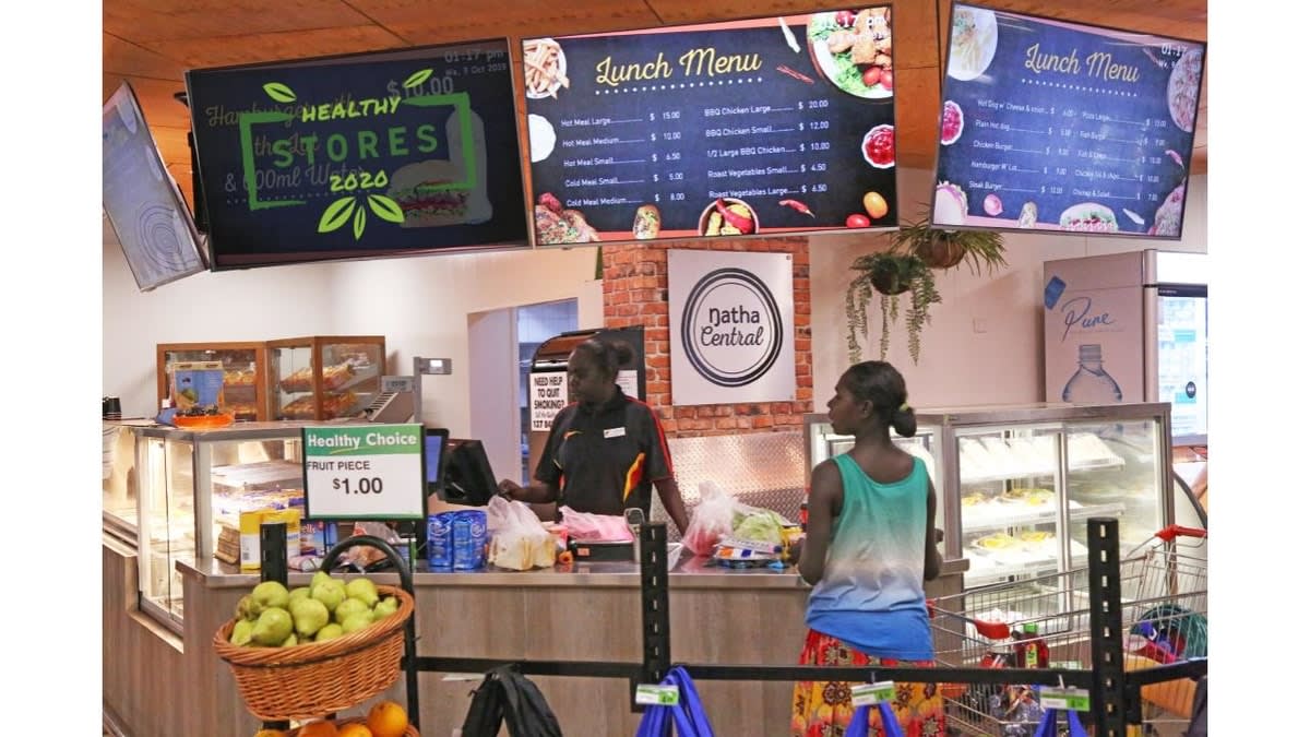 Interior picture of a woman serving a customer in a Healthy Store' in far north Australia