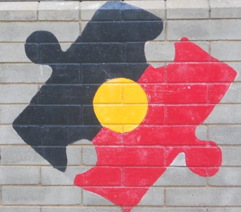 Mural of a jigsaw piece depicting the Indigenous Australia flag